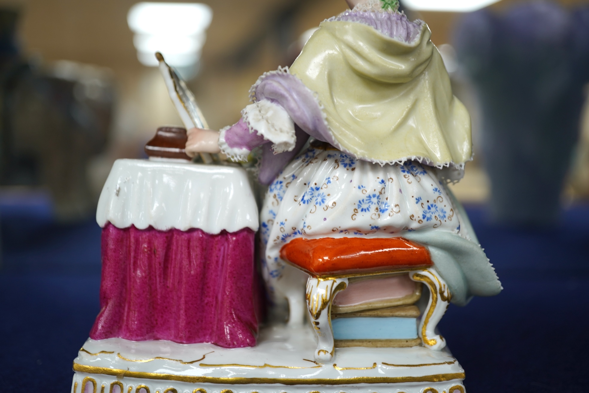 A late 19th century Meissen figure of Sight, from the Senses, a seated lady at her dressing table, crossed swords mark and incised E3 mark to base, 14cm high